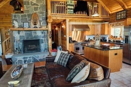 15 Stephanie Ln, Peru, MA 01235 - living area with light tile patterned floors, wood ceiling with exposed beams, a fireplace, and high vaulted ceiling