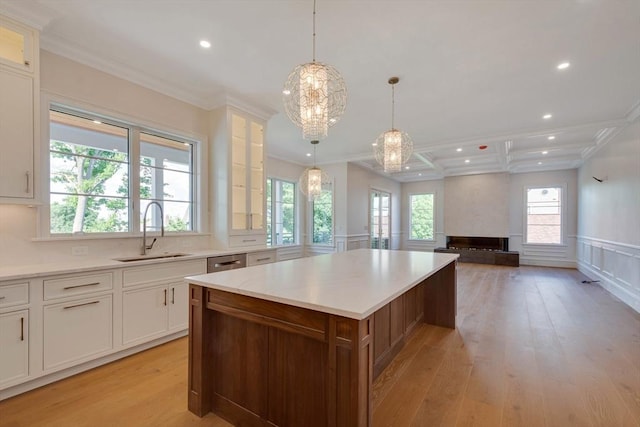 kitchen featuring high quality appliances, pendant lighting, a spacious island, decorative backsplash, and white cabinets