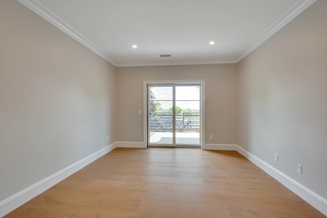 spare room with light hardwood / wood-style flooring and ornamental molding