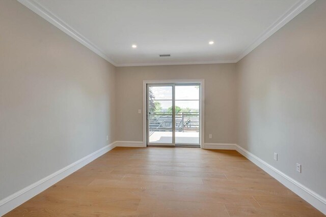 spare room with ornamental molding and light wood-type flooring