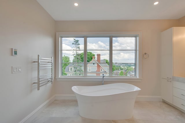 bathroom featuring a tub and vanity