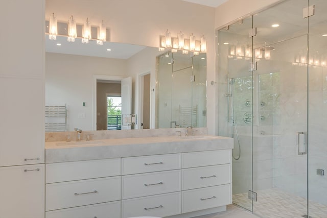 bathroom featuring vanity and a shower with shower door