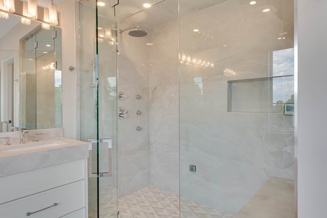 bathroom with vanity and a shower with door