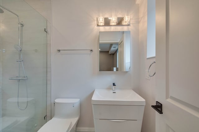 bathroom with vanity, toilet, and a shower with door