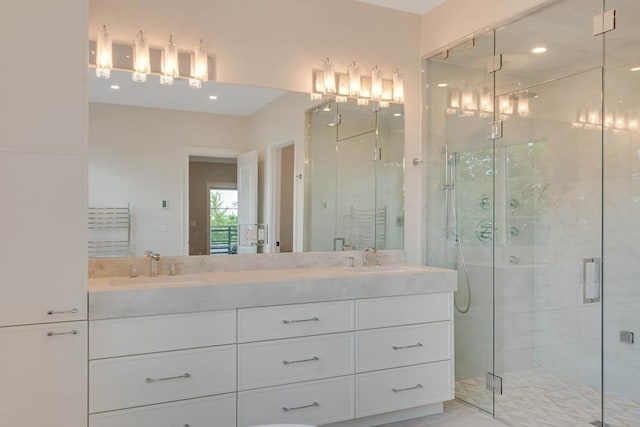 bathroom with vanity, toilet, and a shower with door