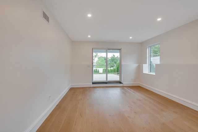 spare room featuring light hardwood / wood-style flooring