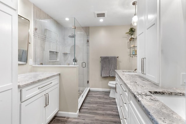 11 Fairway Dr Unit Oceanview, Plymouth, MA 02360 - bathroom featuring toilet, visible vents, vanity, and a stall shower