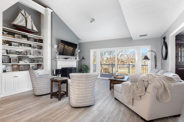 11 Fairway Dr Unit Oceanview, Plymouth, MA 02360 - living room with a fireplace, visible vents, light wood finished floors, and lofted ceiling
