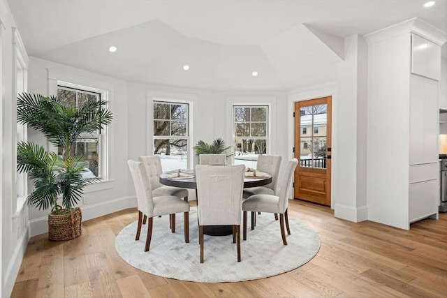 dining space with baseboards, light wood-type flooring, and recessed lighting