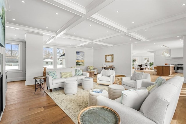 living area with light wood-style flooring, ornamental molding, coffered ceiling, and beamed ceiling