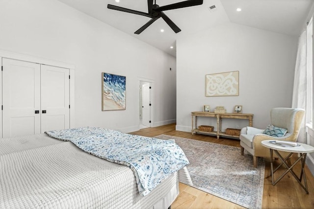 bedroom with recessed lighting, a closet, visible vents, light wood-style flooring, and high vaulted ceiling