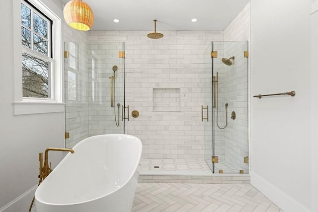 full bath with a stall shower, a freestanding tub, baseboards, and recessed lighting
