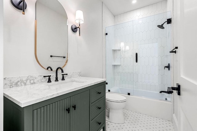 full bathroom with toilet, tile patterned floors, washtub / shower combination, and vanity
