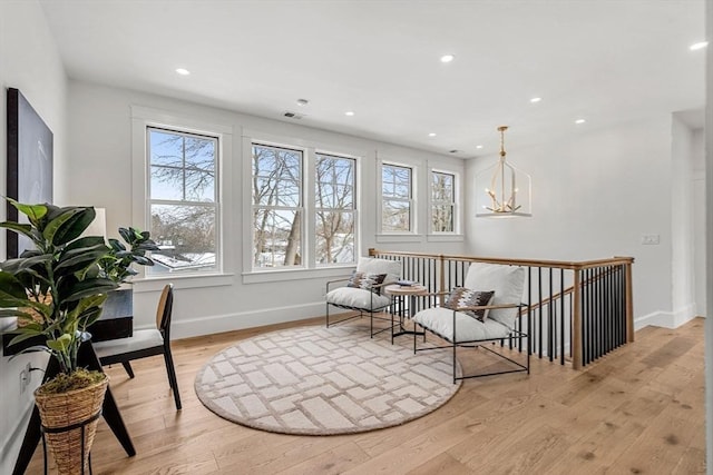 sitting room featuring light wood-style floors, visible vents, baseboards, and recessed lighting