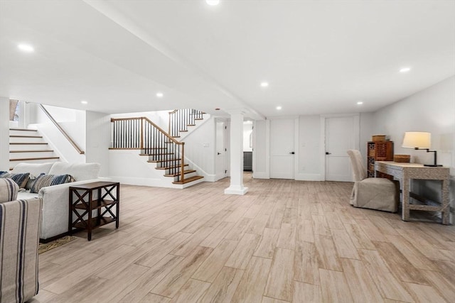 living area featuring stairs, light wood-type flooring, decorative columns, and recessed lighting