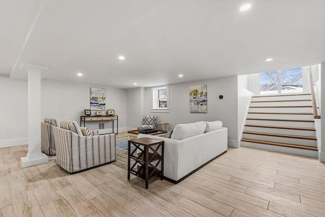 living room with light wood-type flooring, a healthy amount of sunlight, recessed lighting, and stairs