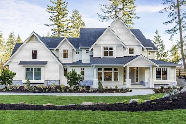 view of front of house with a porch and a front lawn