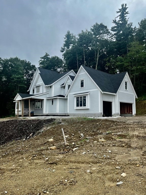 view of front of house featuring a porch and a garage