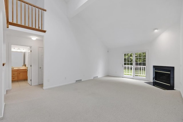 84 Pine Grove Dr Unit 84, South Hadley, MA 01075 - unfurnished living room featuring carpet flooring, a fireplace with flush hearth, and high vaulted ceiling