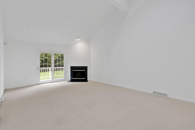 84 Pine Grove Dr Unit 84, South Hadley, MA 01075 - unfurnished living room featuring carpet flooring, lofted ceiling, and a fireplace with flush hearth