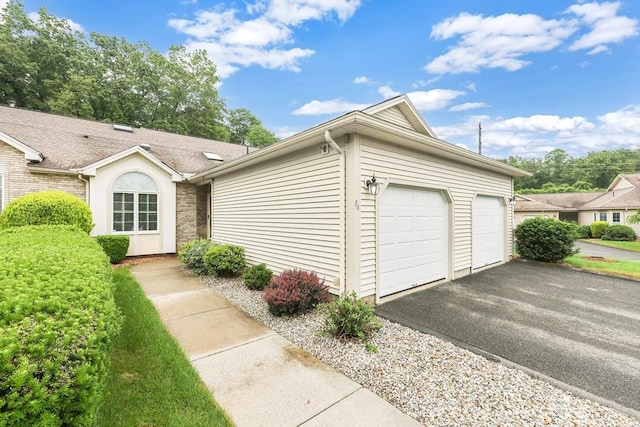 84 Pine Grove Dr Unit 84, South Hadley, MA 01075 - view of front facade featuring a garage and asphalt driveway
