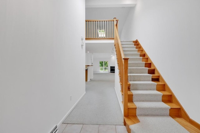 84 Pine Grove Dr Unit 84, South Hadley, MA 01075 - staircase with a towering ceiling, carpet, and tile patterned flooring