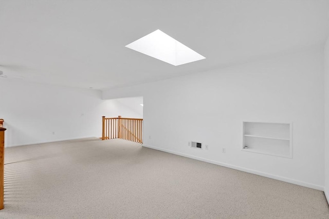 84 Pine Grove Dr Unit 84, South Hadley, MA 01075 - empty room with a skylight, built in shelves, carpet, and lofted ceiling