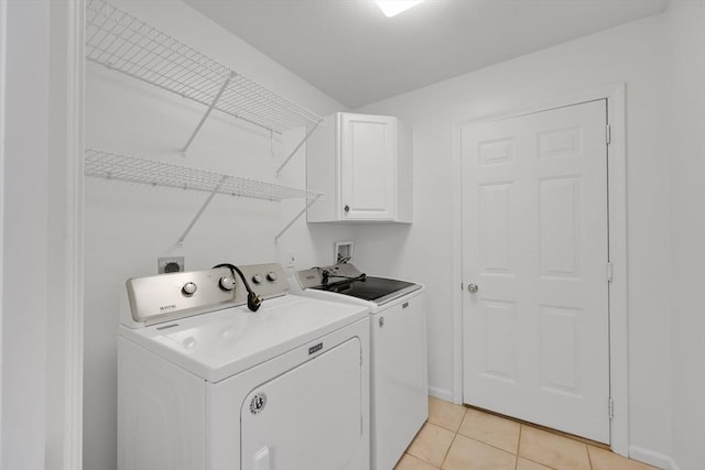 84 Pine Grove Dr Unit 84, South Hadley, MA 01075 - washroom featuring separate washer and dryer, cabinet space, and light tile patterned flooring