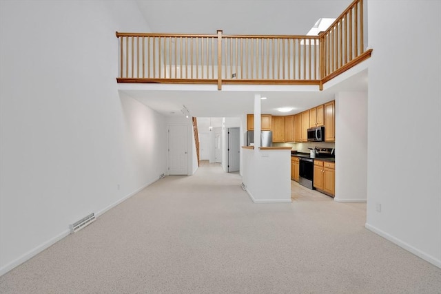 84 Pine Grove Dr Unit 84, South Hadley, MA 01075 - unfurnished living room with light colored carpet and a towering ceiling