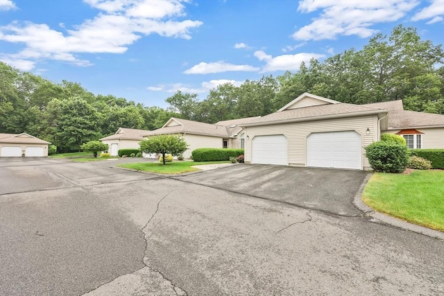 84 Pine Grove Dr Unit 84, South Hadley, MA 01075 - view of front of home featuring an attached garage, asphalt driveway, a front lawn, and view of wooded area