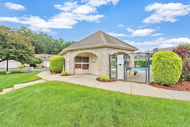 84 Pine Grove Dr Unit 84, South Hadley, MA 01075 - back of property with a gate, a shingled roof, and brick siding