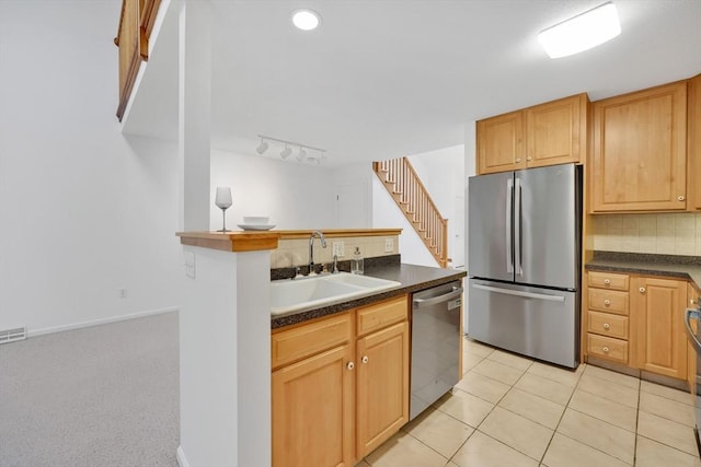84 Pine Grove Dr Unit 84, South Hadley, MA 01075 - kitchen featuring stainless steel appliances, dark countertops, backsplash, and light tile patterned floors