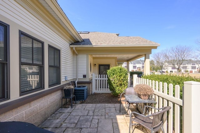 view of patio featuring fence and central AC unit