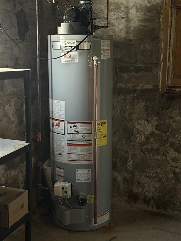utility room featuring water heater