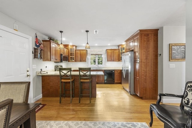 14 Harbor Light Rd, Leominster, MA 01453 - kitchen with appliances with stainless steel finishes, a peninsula, light wood-type flooring, glass insert cabinets, and recessed lighting