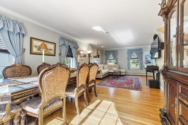 14 Harbor Light Rd, Leominster, MA 01453 - dining space with light wood-style floors, crown molding, and baseboard heating