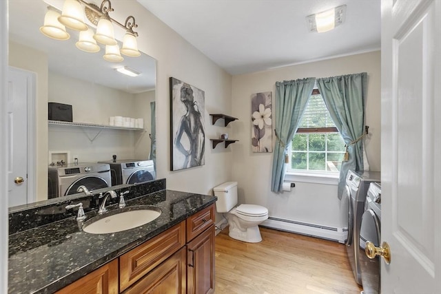 14 Harbor Light Rd, Leominster, MA 01453 - bathroom with separate washer and dryer, a baseboard heating unit, wood finished floors, and vanity