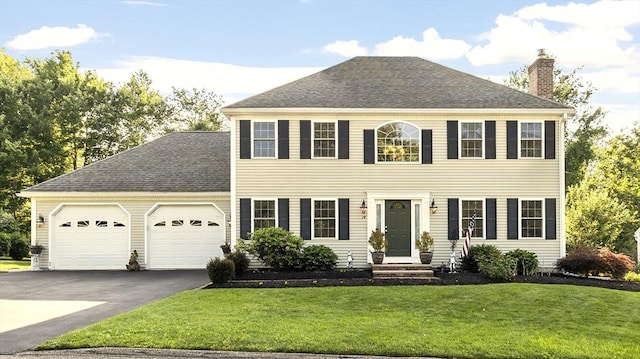 14 Harbor Light Rd, Leominster, MA 01453 - colonial home with a chimney, asphalt driveway, a garage, a front lawn, and a shingled roof