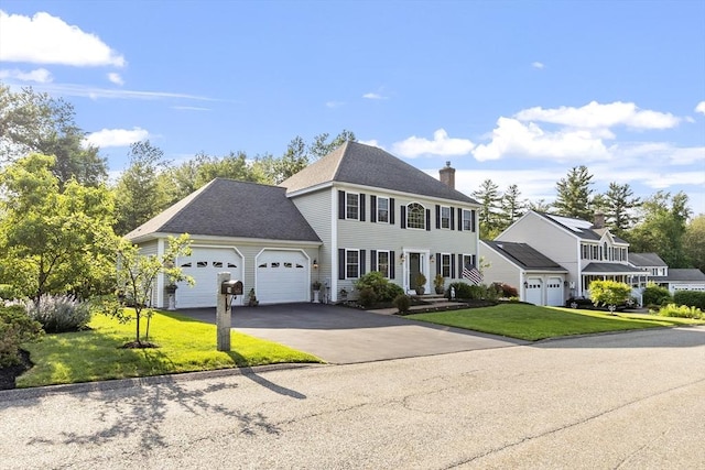 14 Harbor Light Rd, Leominster, MA 01453 - colonial home featuring a chimney, an attached garage, driveway, and a front yard