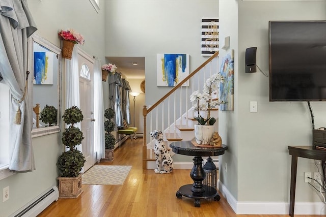 14 Harbor Light Rd, Leominster, MA 01453 - entrance foyer with a baseboard radiator, wood finished floors, stairway, and a high ceiling