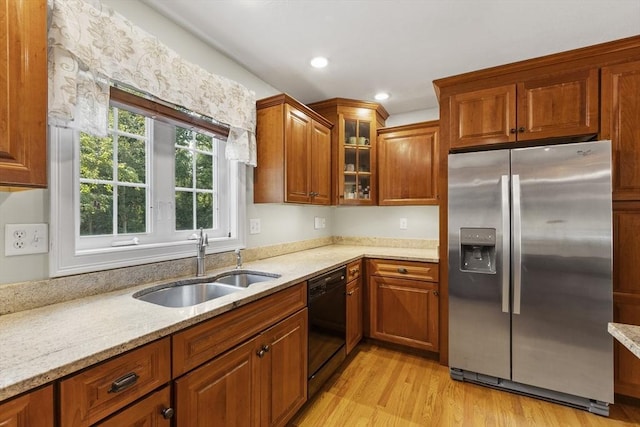 14 Harbor Light Rd, Leominster, MA 01453 - kitchen with stainless steel refrigerator with ice dispenser, black dishwasher, light wood-type flooring, light stone counters, and brown cabinets
