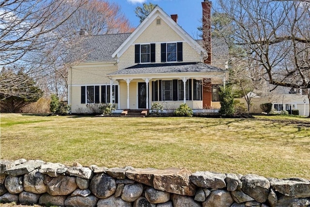 view of front of house featuring a chimney and a front yard