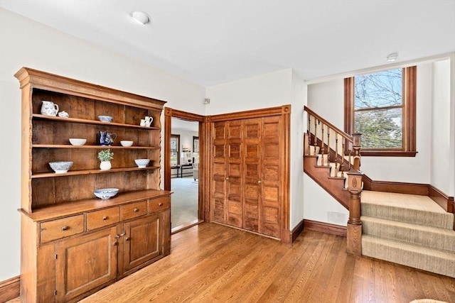 interior space with wood finished floors and baseboards