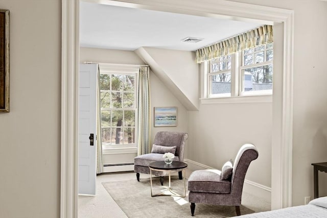 living area featuring visible vents, a baseboard radiator, carpet, and baseboards