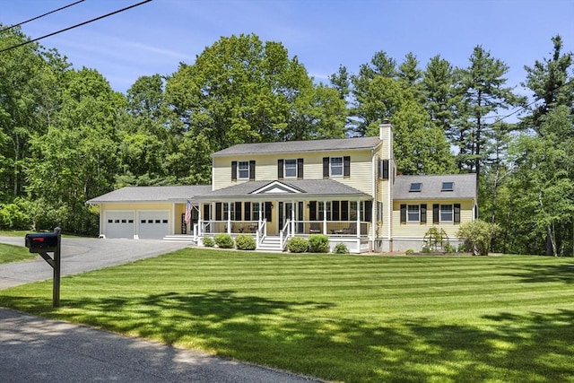 299 Reedy Meadow Rd, Groton, MA 01450 - view of front of home featuring asphalt driveway, a porch, a garage, a chimney, and a front lawn