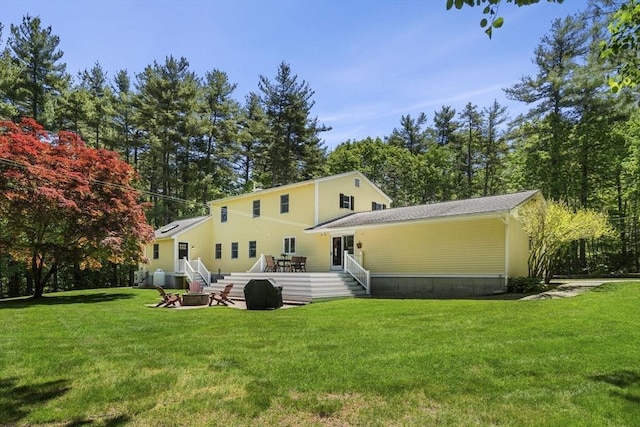 299 Reedy Meadow Rd, Groton, MA 01450 - rear view of property with a yard, a deck, and an outdoor fire pit