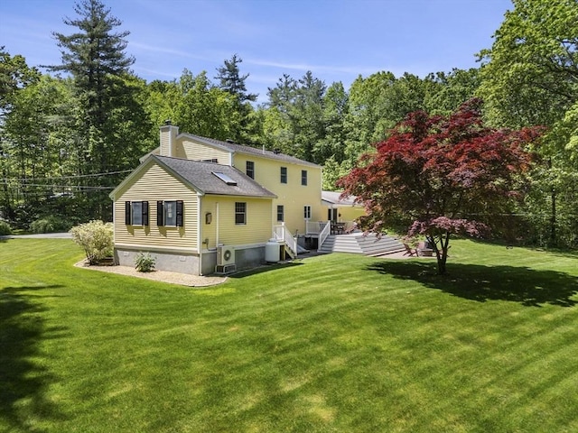 299 Reedy Meadow Rd, Groton, MA 01450 - rear view of house with a chimney, a yard, roof with shingles, and view of wooded area