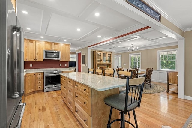 299 Reedy Meadow Rd, Groton, MA 01450 - kitchen with appliances with stainless steel finishes, a breakfast bar, coffered ceiling, crown molding, and light wood finished floors