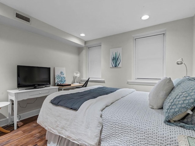 bedroom with wood finished floors, recessed lighting, and baseboards