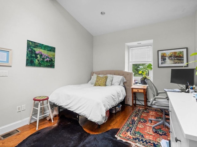289 K St, Boston, MA 02127 - bedroom featuring wood finished floors, baseboards, baseboard heating, a desk, and vaulted ceiling